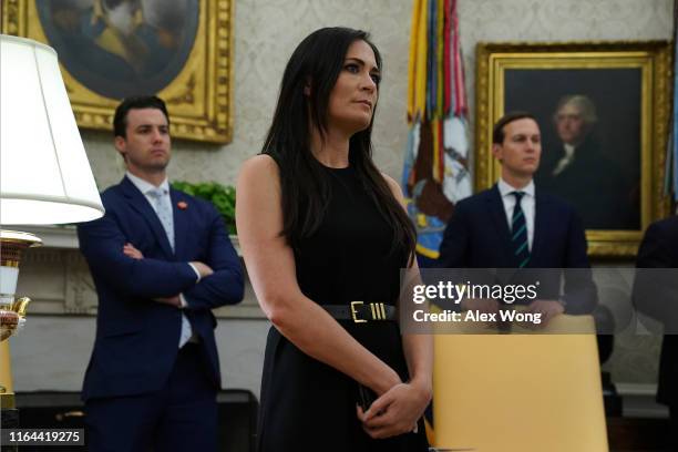 White House Press Secretary Stephanie Grisham listens during a signing of a “safe third country” agreement in the Oval Office of the White House July...