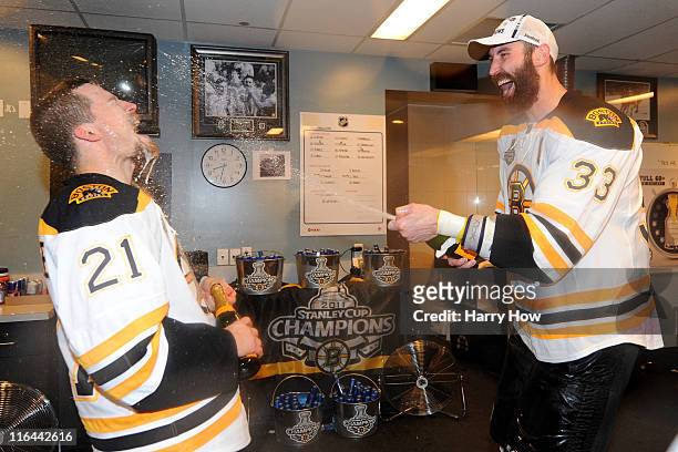 Zdeno Chara and Andrew Ference of the Boston Bruins celebrate in the locker room after defeating the Vancouver Canucks in Game Seven of the 2011 NHL...