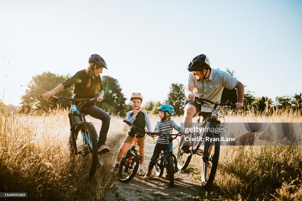 Family Mountain Bike Riding Together on Sunny Day