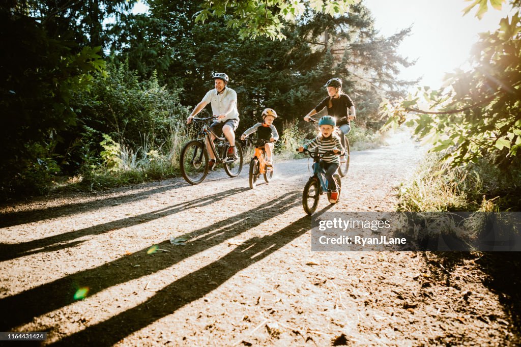 Family Mountain Bike Riding Together on Sunny Day