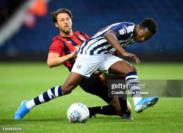 Kyle Edwards of West Bromwich Albion is challenged by Harry Arter of Bournemouth during the Pre-Season Friendly match between West Bromwich Albion...