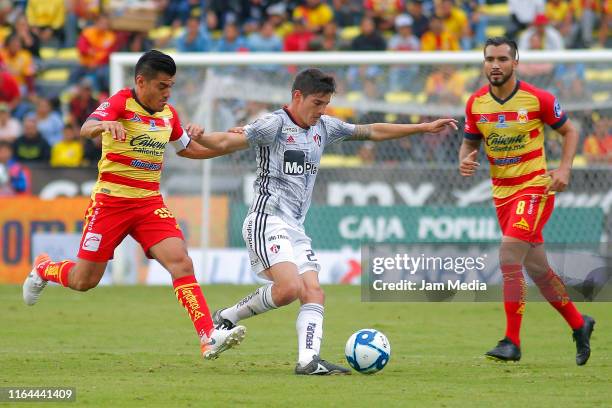 Aldo Rocha , Mario Osuna of Morelia fights for the ball with Edson Rivera of Atlas during the 2nd round match between Morelia and Atlas as part of...