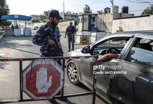 Security forces loyal to Palestinian Islamist movement Hamas stop a vehicle at a checkpoint in Khan Yunis in the southern Gaza Strip on August 28,...