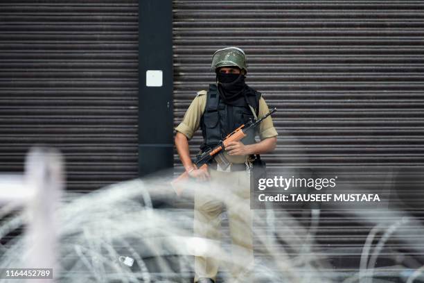 Security personnel stands guard on a street in Srinagar on August 28, 2019. - The Himalayan valley is under a strict lockdown -- with movement...