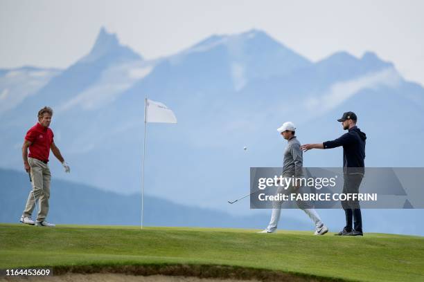 Actor Dennis Quaid, Northern Ireland's Rory McIlroy and US singer-songwriter Justin Timberlake are seen with the Swiss Alps in the background during...