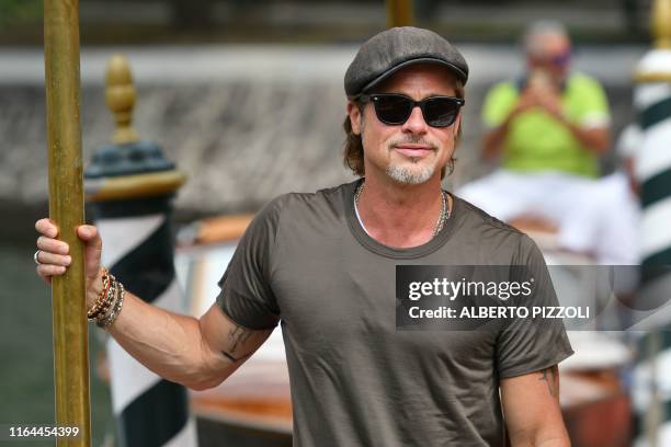 Actor Brad Pitt poses as he arrives by taxi boat on August 28, 2019 during the 76th Venice Film Festival at Venice Lido.