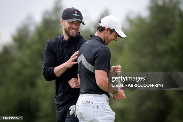 Singer-songwriter Justin Timberlake reacts with Northern Ireland's Rory McIlroy after competing in a pro-am tournament ahead of the PGA European Tour...