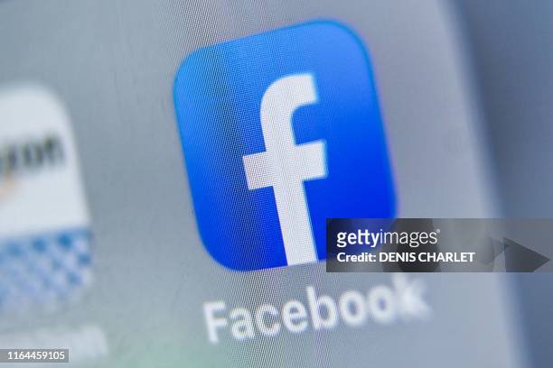 Picture taken on August 28, 2019 shows the logo of US online social media and social networking service, Facebook displayed on a tablet in Lille.