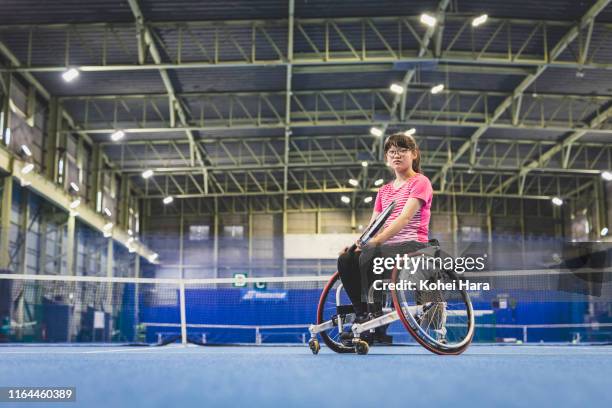 portrait of disabled female athlete playing wheel chair tennis - wheelchair tennis stock pictures, royalty-free photos & images