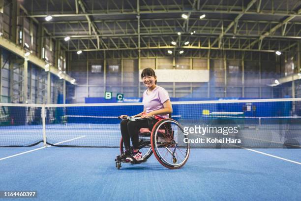 Portrait of Disabled female athlete playing wheel chair tennis