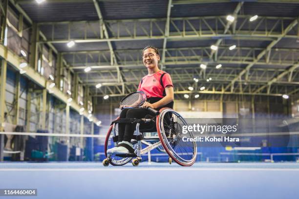 portrait of disabled female athlete playing wheel chair tennis - wheelchair tennis stock pictures, royalty-free photos & images