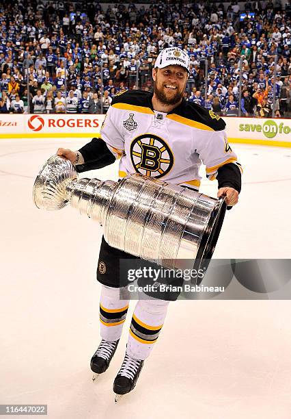 Dennis Seidenberg of the Boston Bruins celebrates winning the Stanley Cup after defeating the Vancouver Canucks 4-0 in Game Seven of the 2011 NHL...
