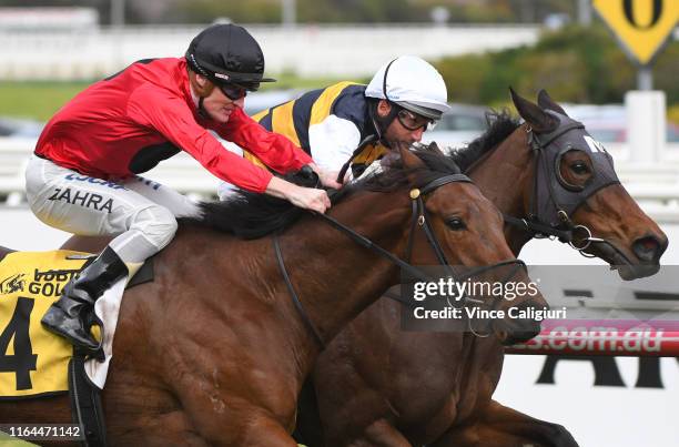 Damien Oliver riding Benitoite defeats Mark Zahra riding Taksu in Race 6 during Melbourne Racing at Caulfield Racecourse on July 27, 2019 in...