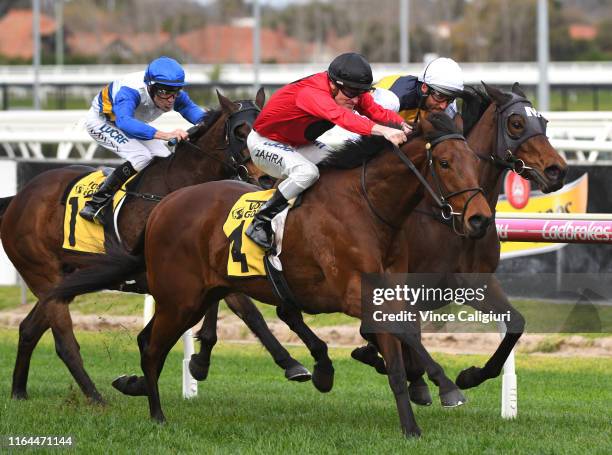 Damien Oliver riding Benitoite defeats Mark Zahra riding Taksu in Race 6 during Melbourne Racing at Caulfield Racecourse on July 27, 2019 in...