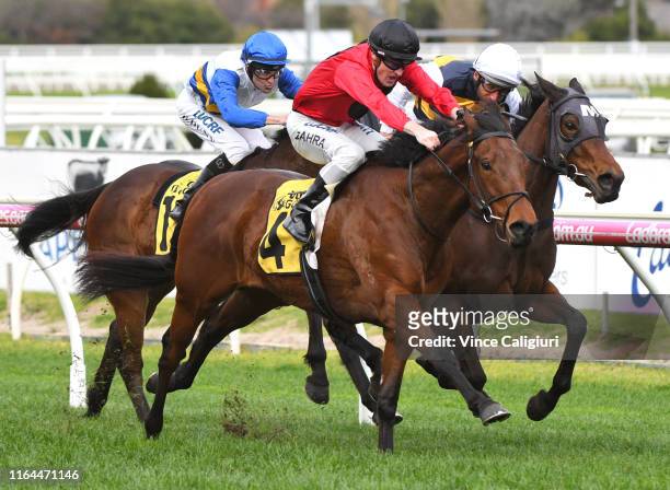 Damien Oliver riding Benitoite defeats Mark Zahra riding Taksu in Race 6 during Melbourne Racing at Caulfield Racecourse on July 27, 2019 in...
