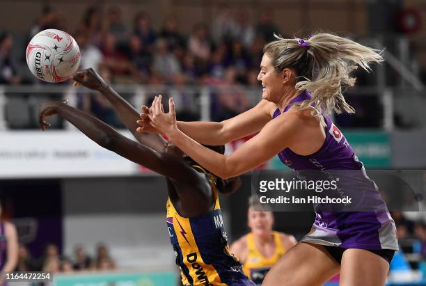 Gretal Tippett of the Firebirds and Phumza Maweni of the Lightning contest the ball during the round 10 Super Netball match between the Firebirds and...