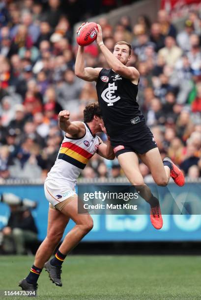 Harry McKay of the Blues is challenged by Kyle Hartigan of the Crows during the round 19 AFL match between the Carlton Blues and the Adelaide Crows...