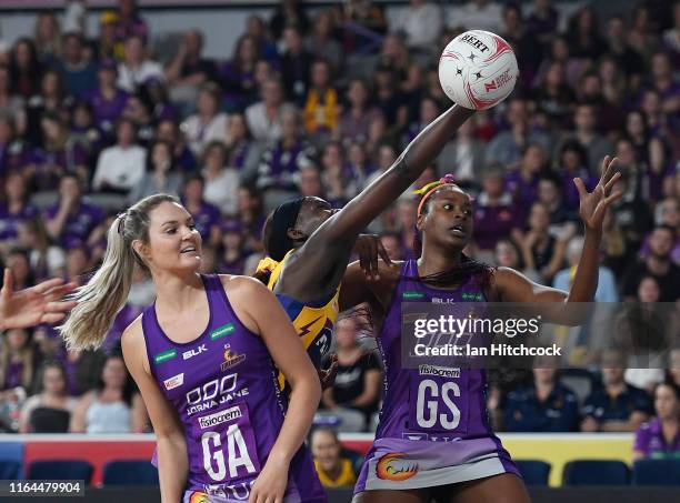 Phumza Maweni of the Lightning contests the ball with Romelda Aiken and Gretal Tippett of the Firebirds during the round 10 Super Netball match...