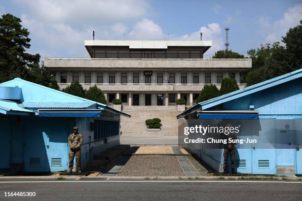 South Korean and US soldier stand guard at the border village of Panmunjom between South and North Korea during a ceremony to commemorate the 66th...