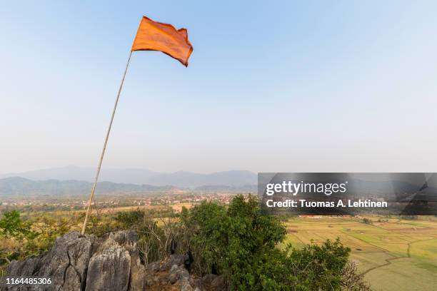 scenic landscape in vang vieng, laos - mountain peak with flag stock pictures, royalty-free photos & images