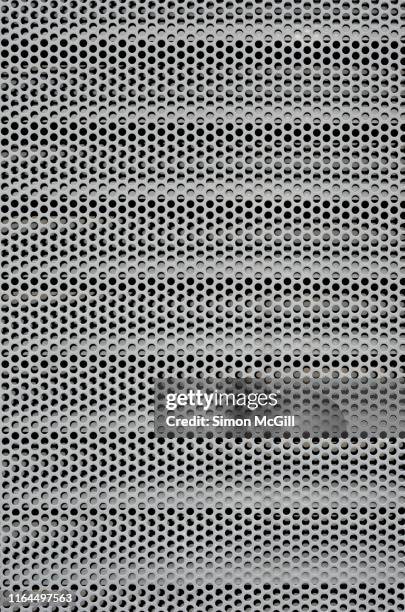 circular perforated steel mesh cover over air conditioning vents - grille en métal photos et images de collection