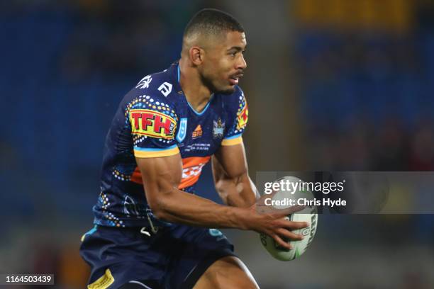 Kallum Watkins of the Titans runs the ball during the round 19 match between the Gold Coast Titans and the Brisbane Broncos at Cbus Super Stadium on...