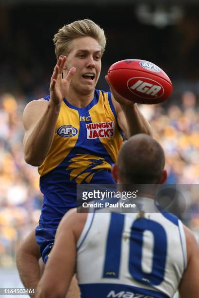 Oscar Allen of the Eagles taps the ball down in a ruck contest during the round 19 AFL match between the West Coast Eagles and the North Melbourne...