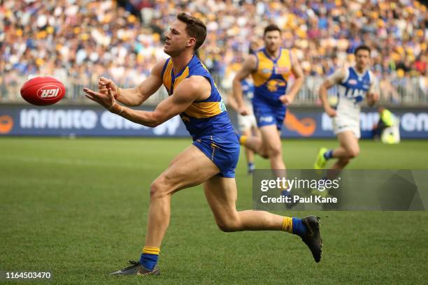 Jack Redden of the Eagles handballs during the round 19 AFL match between the West Coast Eagles and the North Melbourne Kangaroos at Optus Stadium on...