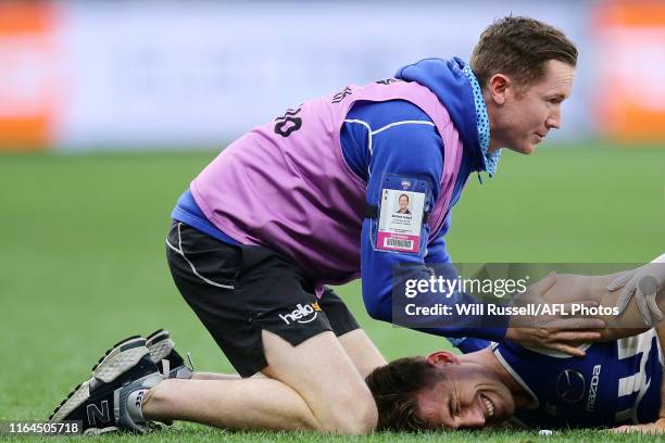 Shaun Atley of the Kangaroos lies on the the field injured during the round 19 AFL match between the West Coast Eagles and the North Melbourne...