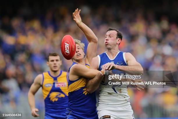 Todd Goldstein of the Kangaroos contests a ruck with Oscar Allen of the Eagles during the round 19 AFL match between the West Coast Eagles and the...