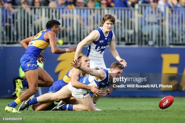 Cameron Zurhaar of the Kangaroos is tackled by Dom Sheed of the Eagles during the round 19 AFL match between the West Coast Eagles and the North...