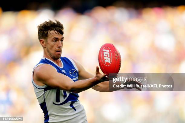 Trent Dumont of the Kangaroos juggles the ball during the round 19 AFL match between the West Coast Eagles and the North Melbourne Kangaroos at Optus...