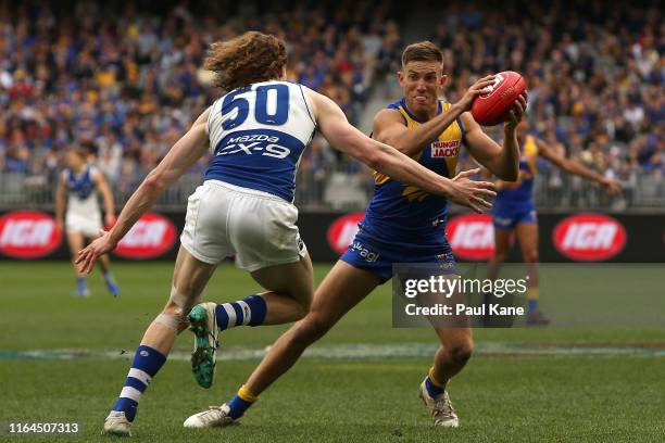 Jack Redden of the Eagles looks to avoid being tackled by Ben Brown of the Kangaroos during the round 19 AFL match between the West Coast Eagles and...