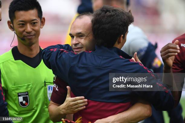 Andres Iniesta of Vissel Kobe and Riqui Puig of FC Barcelona hug prior to the preseason friendly match between Vissel Kobe and Barcelona at Noevir...