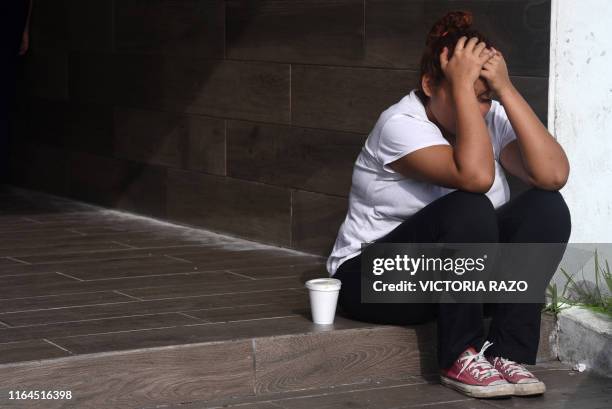 Relative of a victim sits outside the General Prosecutor's Office of the state of Veracruz on August 28, 2019 in Coatzacoalcos, where at least 26...