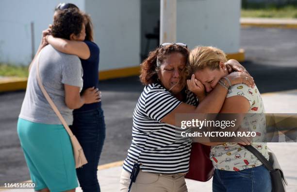 Relatives and friends of victims embrace each other outside the General Prosecutor's Office of the state of Veracruz on August 28, 2019 in...