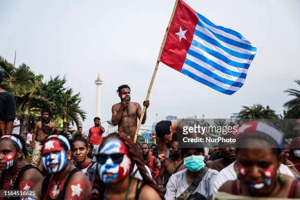 Papuan student waves the West Papua flag, the Morning Star during a rally in Jakarta, Indonesia, on August 28, 2019. Student and activist gathered...