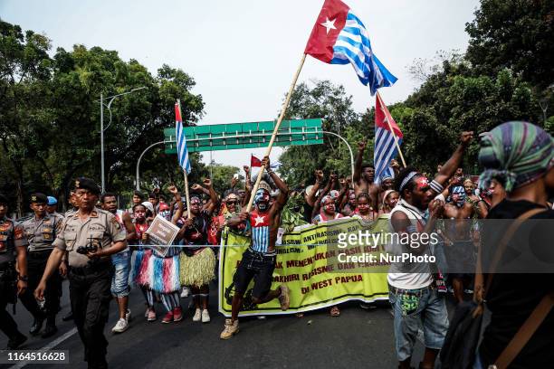 Papuan student waves the West Papua flag, the Morning Star during a rally in Jakarta, Indonesia, on August 28, 2019. Student and activist gathered...