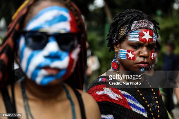 Papuan students paint her face with the West Papua flag, the Morning Star during a rally in Jakarta, Indonesia, on August 28, 2019. Student and...