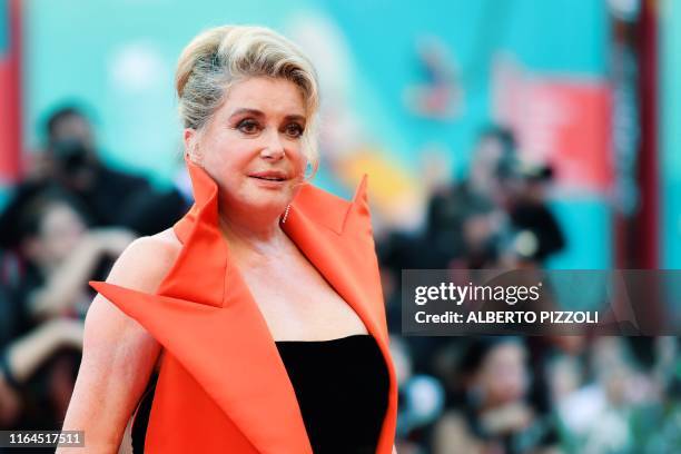 French actress Catherine Deneuve arrives for the opening ceremony and the screening of the film "La Verite" presented in competition on August 28,...