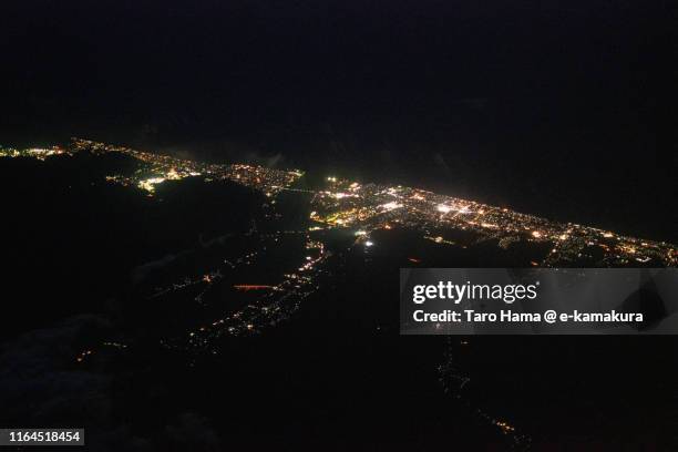 sea of japan and itoigawa city in niigata prefecture of japan night time aerial view from airplane - prefeitura de niigata imagens e fotografias de stock