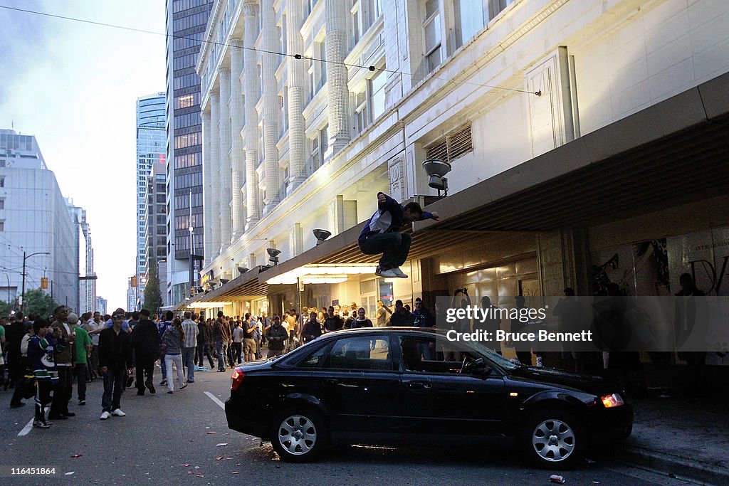 Bc Riot A rioter jumps on the top of a car on June 15, 2011 in Vancouver ...
