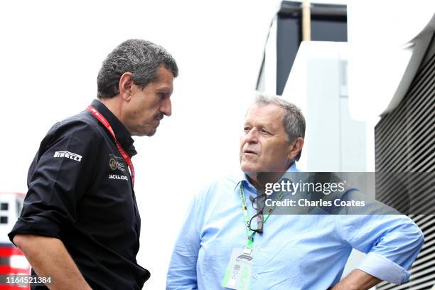 Haas F1 Team Principal Guenther Steiner talks with Norbert Haug in the Paddock before final practice for the F1 Grand Prix of Germany at...
