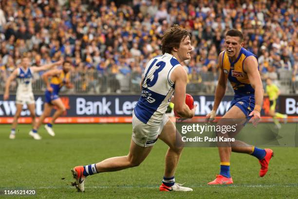 Jared Polec of the Kangaroos looks to pass the ball during the round 19 AFL match between the West Coast Eagles and the North Melbourne Kangaroos at...