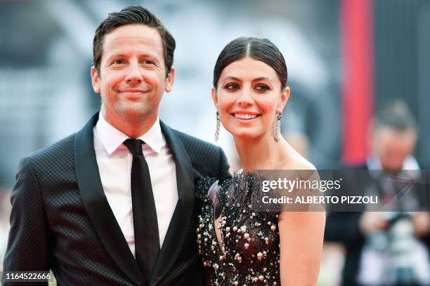 Italian actress and sponsor of the Festival, Alessandra Mastronardi and her boyfriend Scottish actor Ross McCall pose as they arrive for the opening...