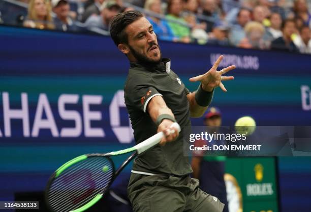 Damir Dzumhur of Bosnia and Herzegovina hits a return to Roger Federer of Switzerland during the second round of the men's 2019 US Open tennis...