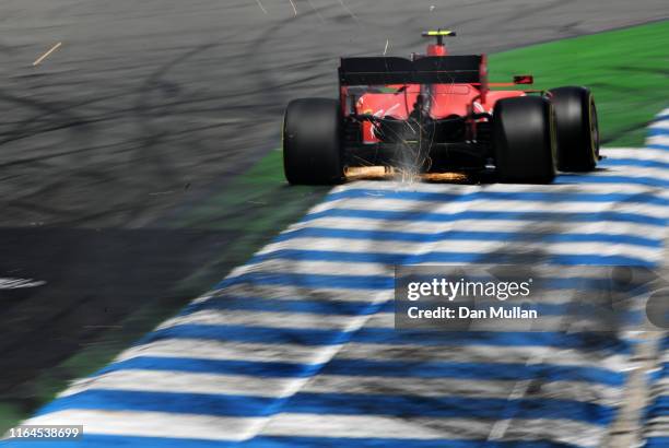 Sparks fly behind Charles Leclerc of Monaco driving the Scuderia Ferrari SF90 on track during qualifying for the F1 Grand Prix of Germany at...