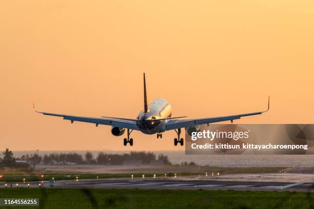 plane landing at airport - aerodrome stock-fotos und bilder