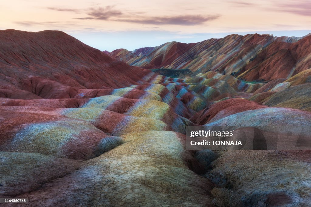 Zhangye Danxia National Geopark, Gansu, China. Colorful landscape of rainbow mountains. Walking paths around sandstone rock formation at Zhangye National Geological Park.