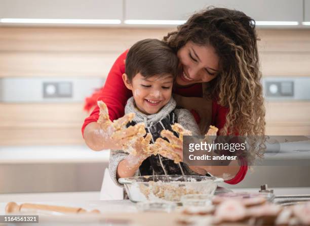 mother and son having fun baking cookies - cooking mess imagens e fotografias de stock